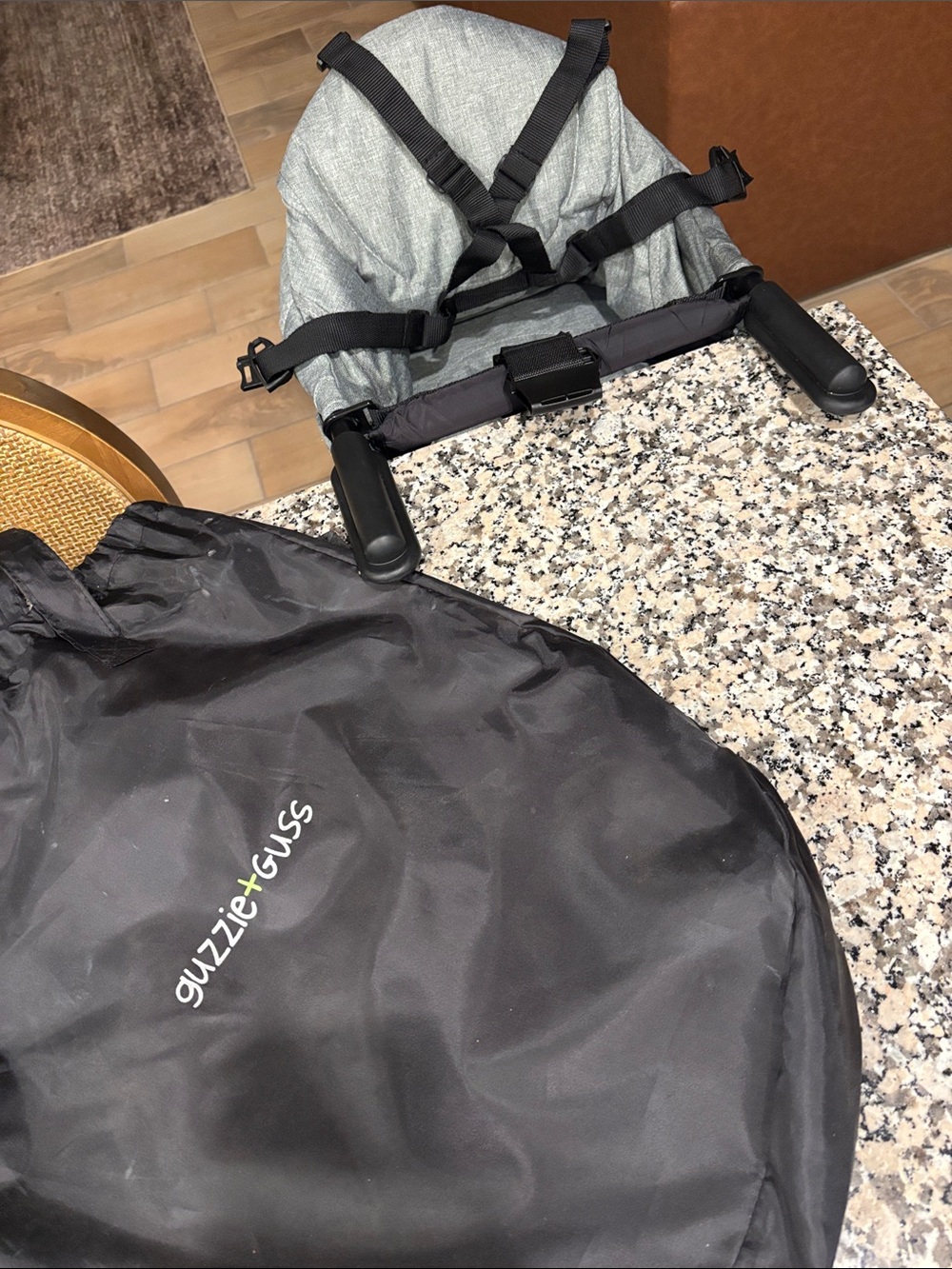 Guzzie + Guss grey travel high chair with black bag